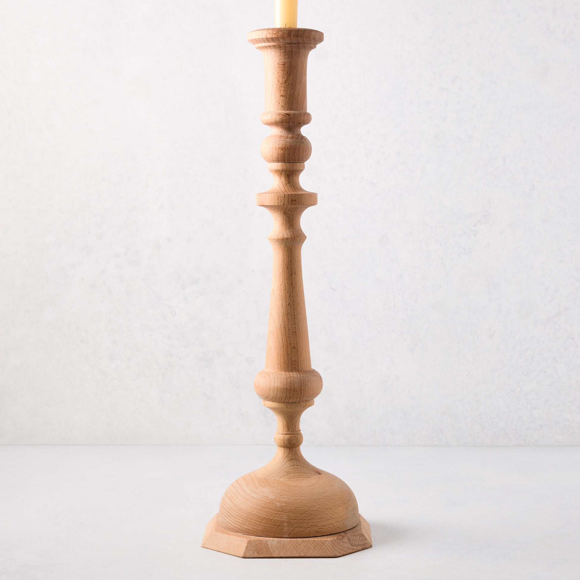 Large natural beechwood Georgian candlestick, 19"H, with a cream candle.