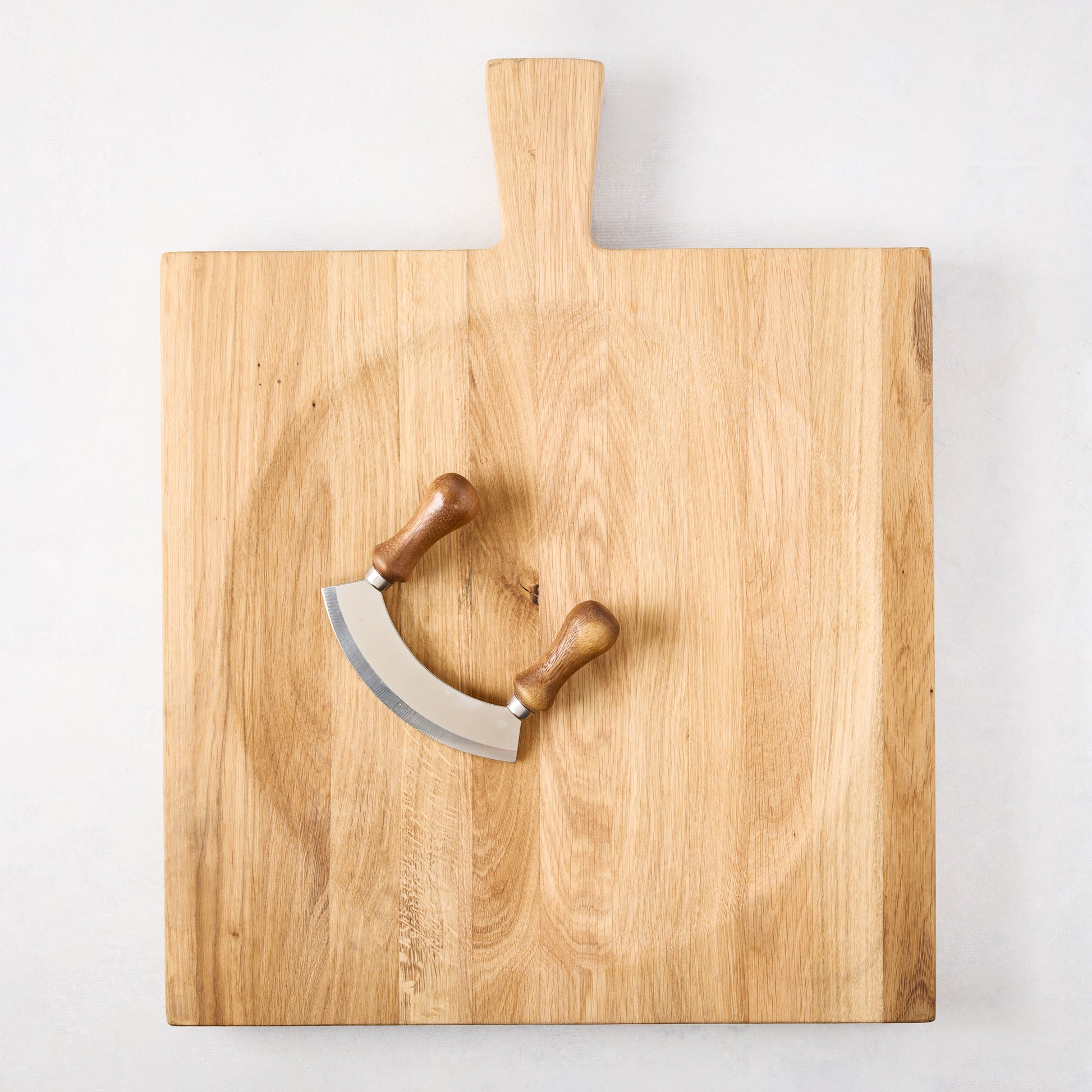 Large reclaimed oak wood cutting board bowl with a mezzaluna blade.