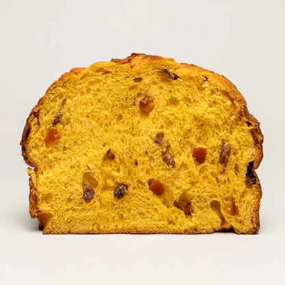 Slice of golden-yellow Olivieri classic panettone with visible raisins and candied orange pieces on a white background.