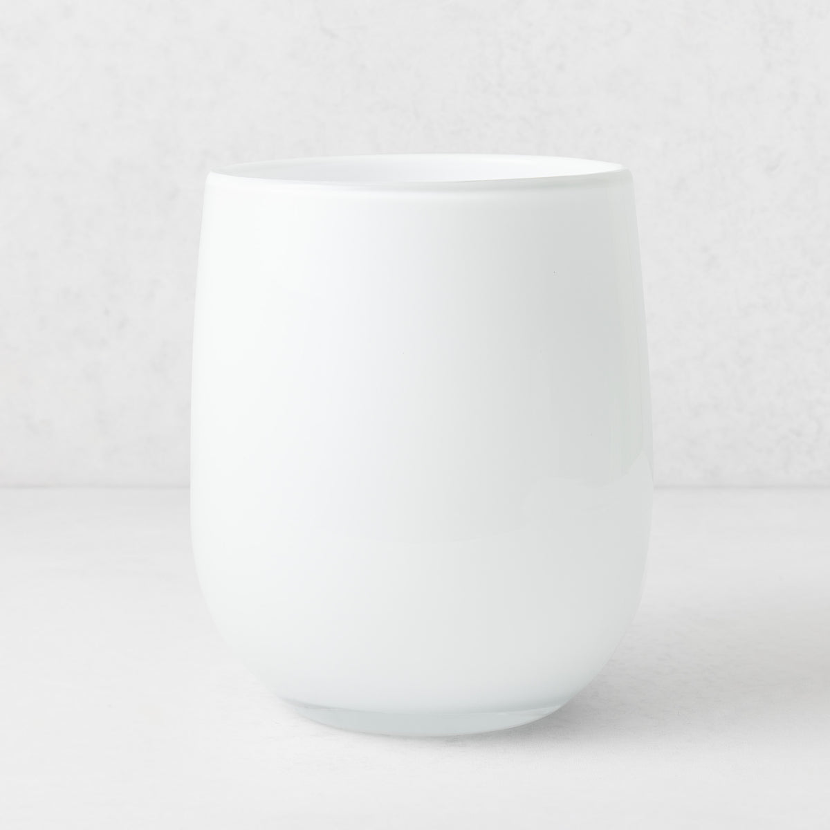 Handblown opaque white glass barrel vase with a modern curved silhouette, 9 inches tall.