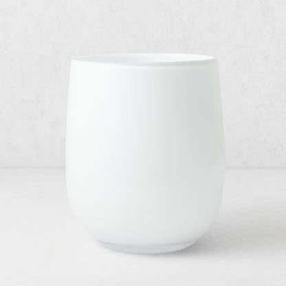 Handblown opaque white glass barrel vase with a modern curved silhouette, 9 inches tall.