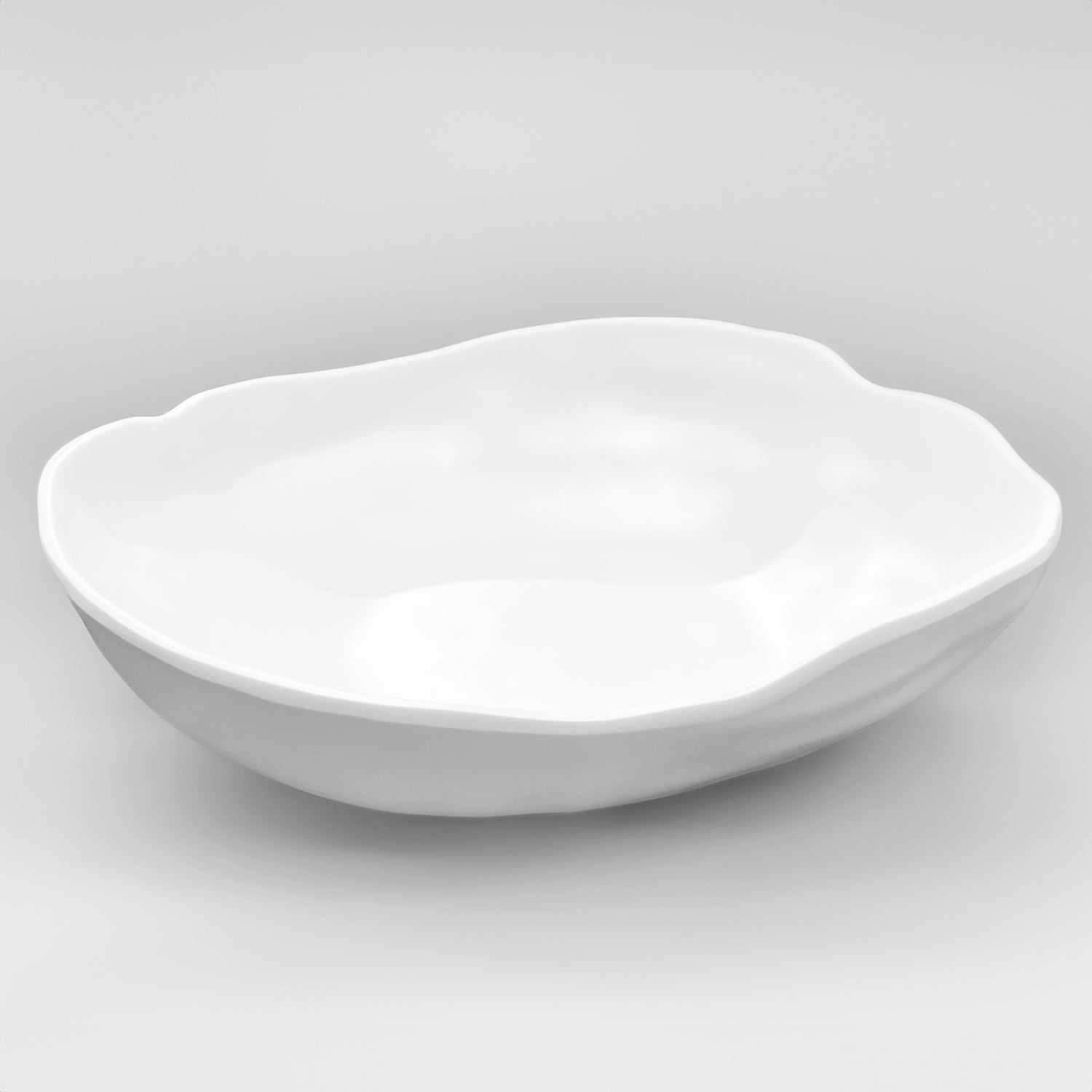Large white organic melamine serve bowl with a sculptural shape.