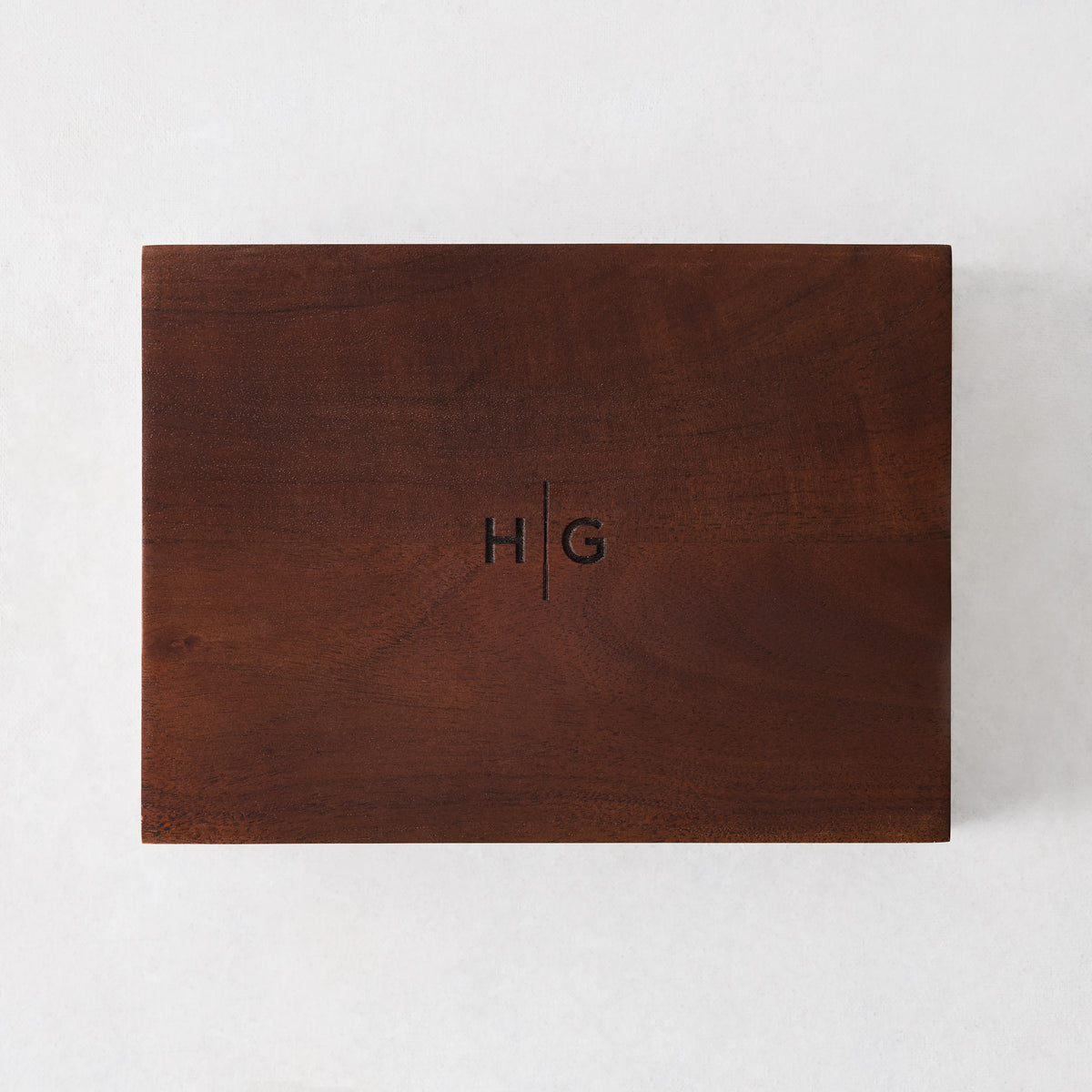 Large rectangular matchbox made of dark walnut wood with an engraved HG monogram on the lid.