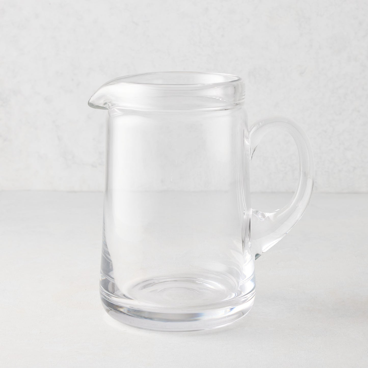 Large Oxford clear glass pitcher with hand-molded rim and handle.