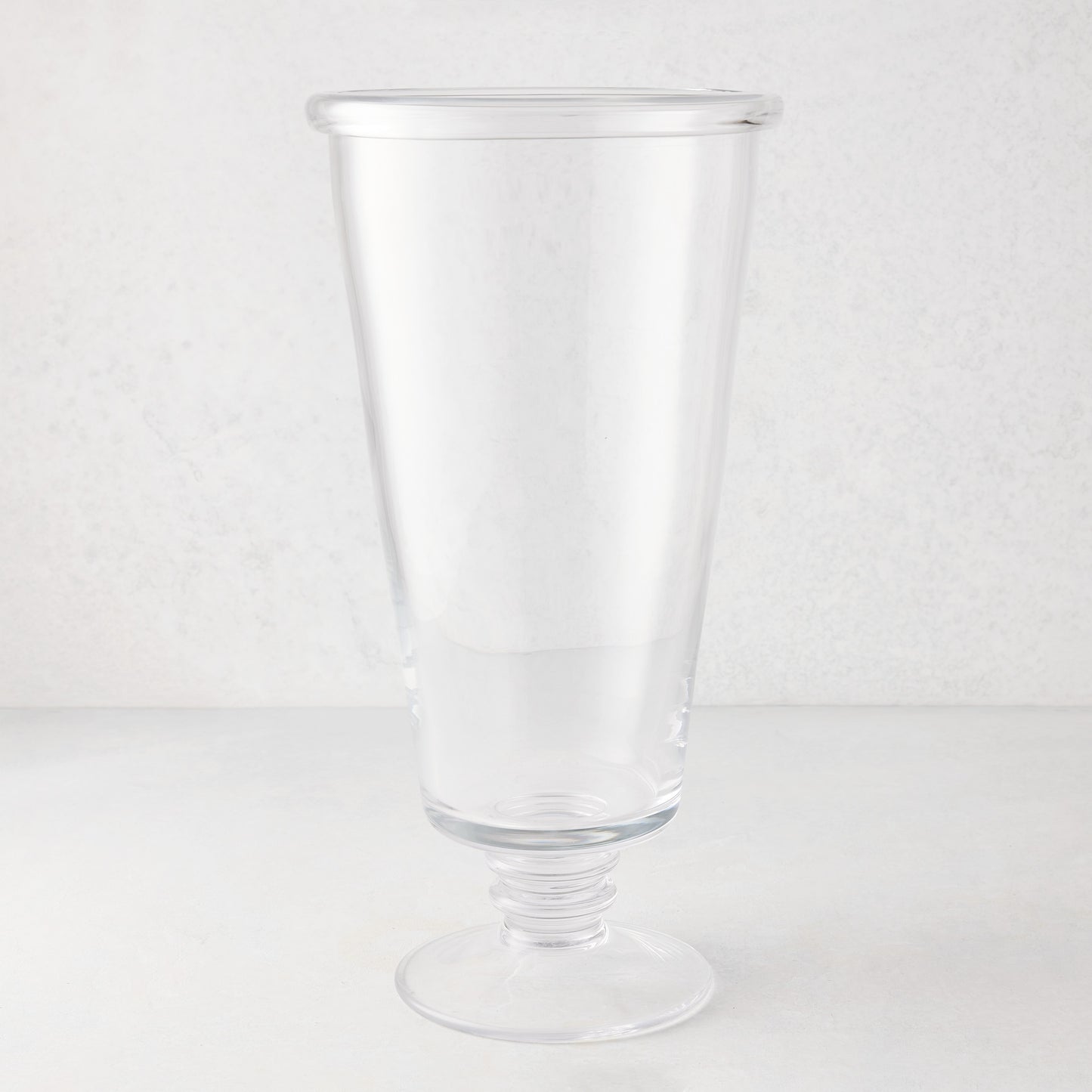Large Oxford clear glass vase with a hand-molded, folded rim and ribbed base.