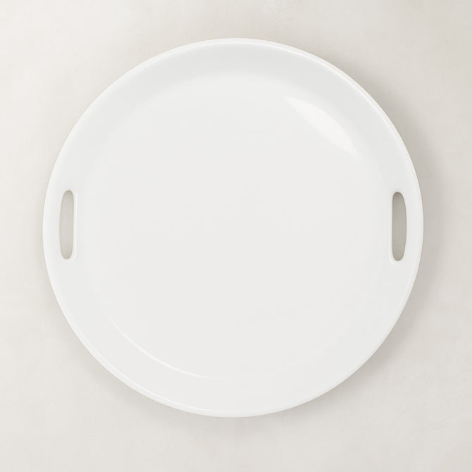 Creamy white ceramic round serving tray with integrated handles, 16.5" diameter.