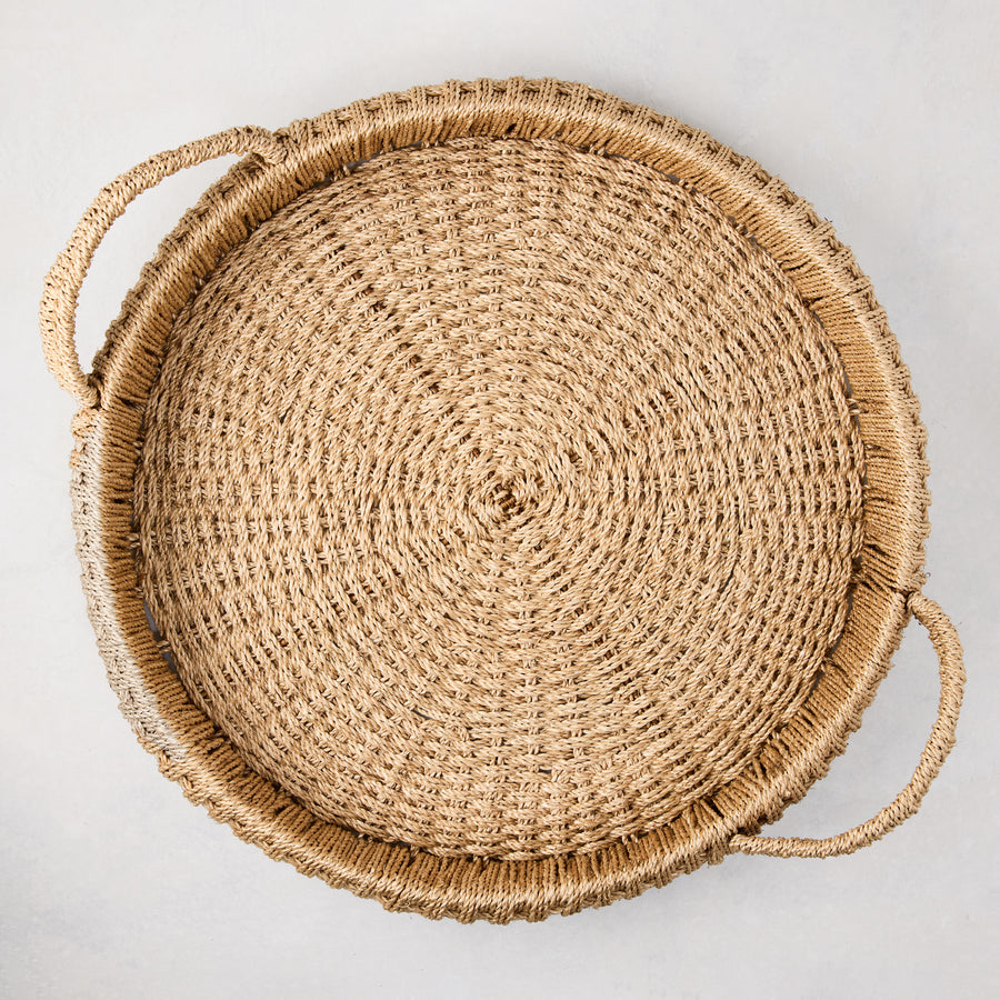 Large round woven abaca handled tray, natural brown, 20" diameter, with integrated handles.