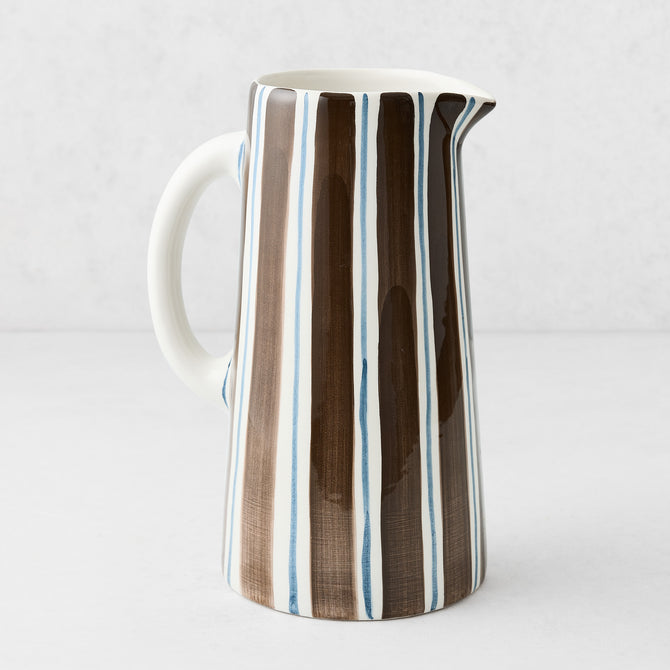 Large Italian ceramic pitcher with hand-painted navy and chocolate brown vertical stripes on a white glazed finish.