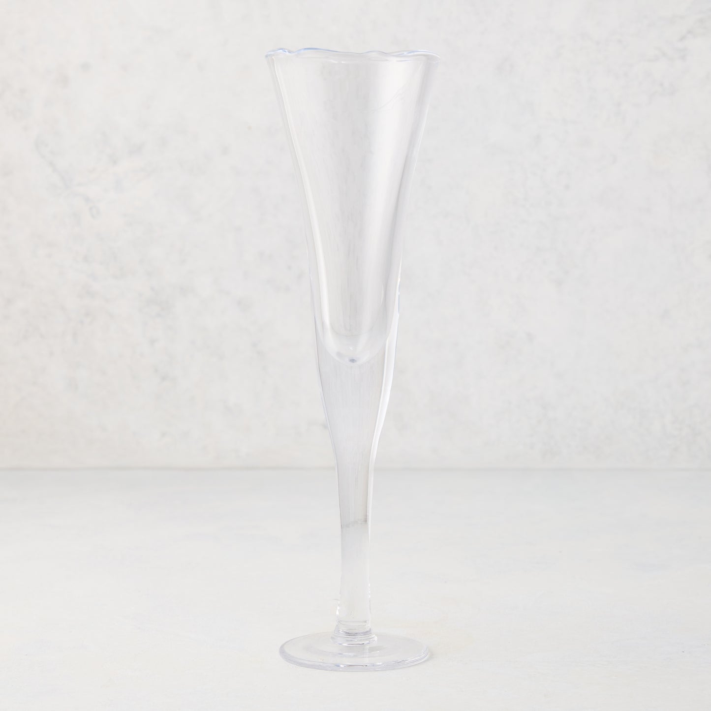 Clear, tall scissor-cut glass champagne flute with a rippled rim, 12 oz.