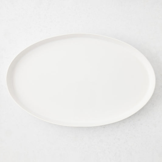 Large white oval stoneware serving platter with a minimalist design, handmade in Portugal.