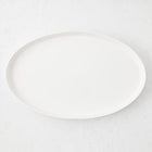 Large white oval stoneware serving platter with a minimalist design, handmade in Portugal.