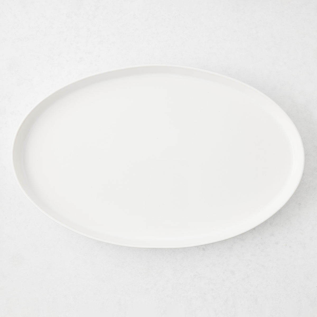 Large white oval stoneware serving platter with a minimalist design, handmade in Portugal.