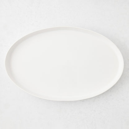 Large white oval stoneware serving platter with a minimalist design, handmade in Portugal.