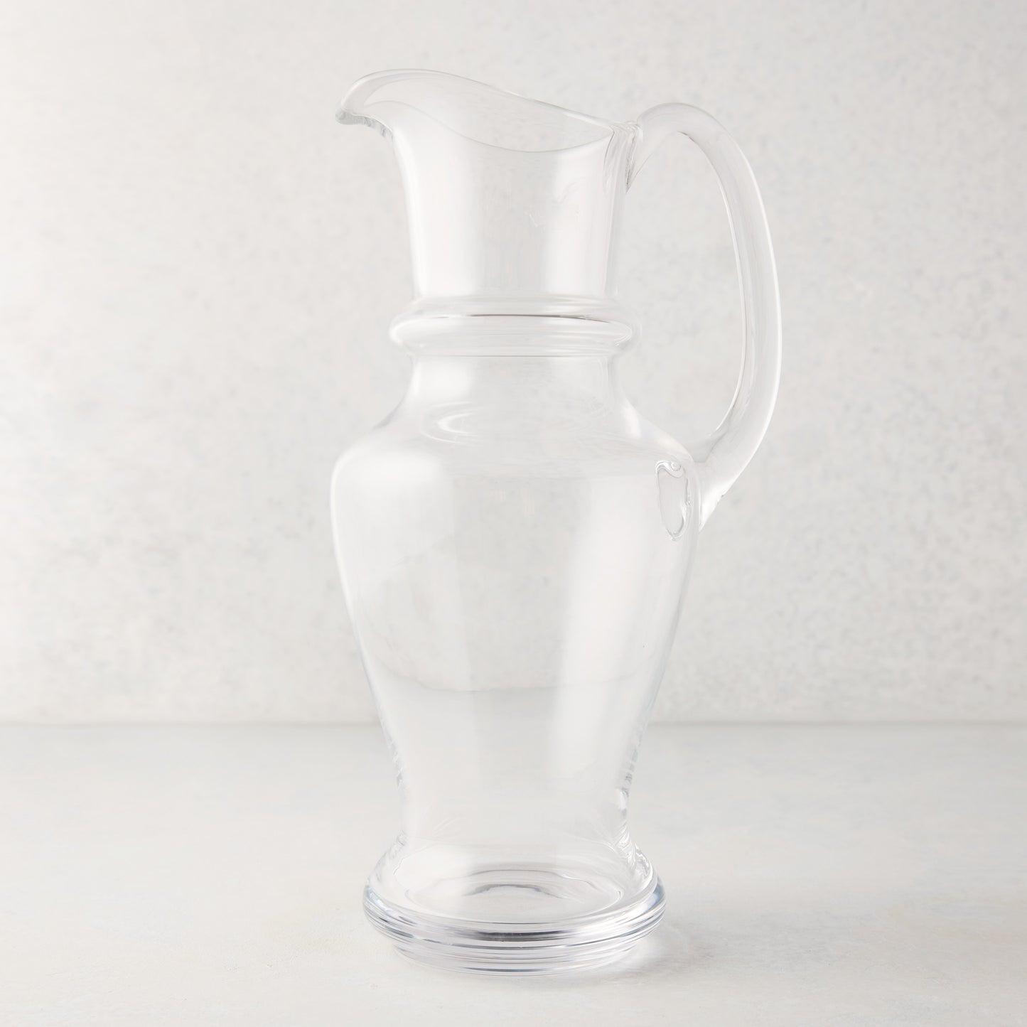 Clear, hand-blown Sutton Glass Pitcher with unique shape and handle, 13"H.