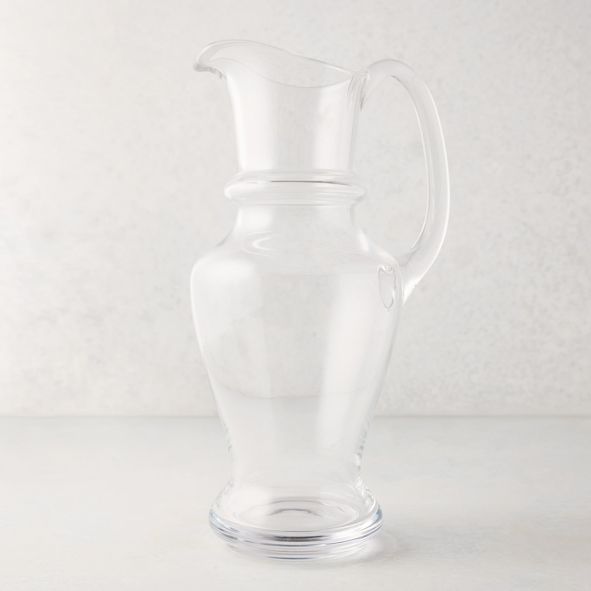 Clear, hand-blown Sutton Glass Pitcher with unique shape and handle, 13"H.