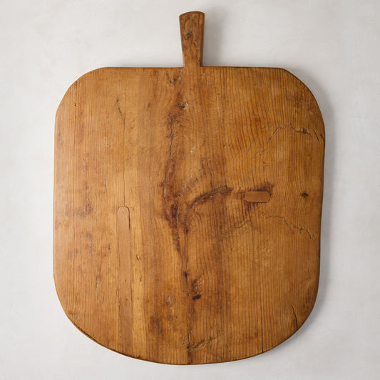 Large vintage reclaimed wood serving board with handle, natural grain, knots, and rich patina.