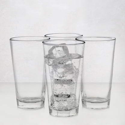 Four clear, tall Hudson Grace drinking glasses; one filled with water and ice.