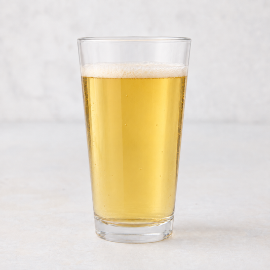Clear 12oz tall drinking glass filled with golden beer, featuring a thick-walled base on a white surface.