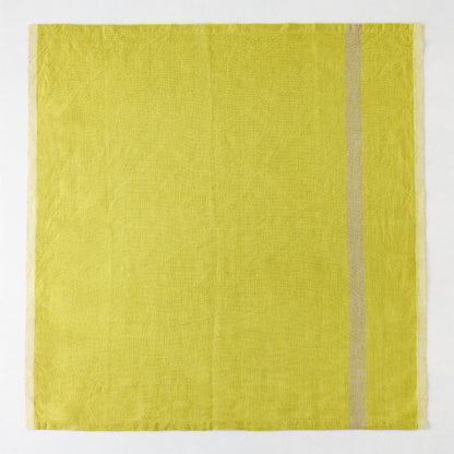 Laundered lime green linen napkin with a paler stripe on the right and a thin stripe on the left.