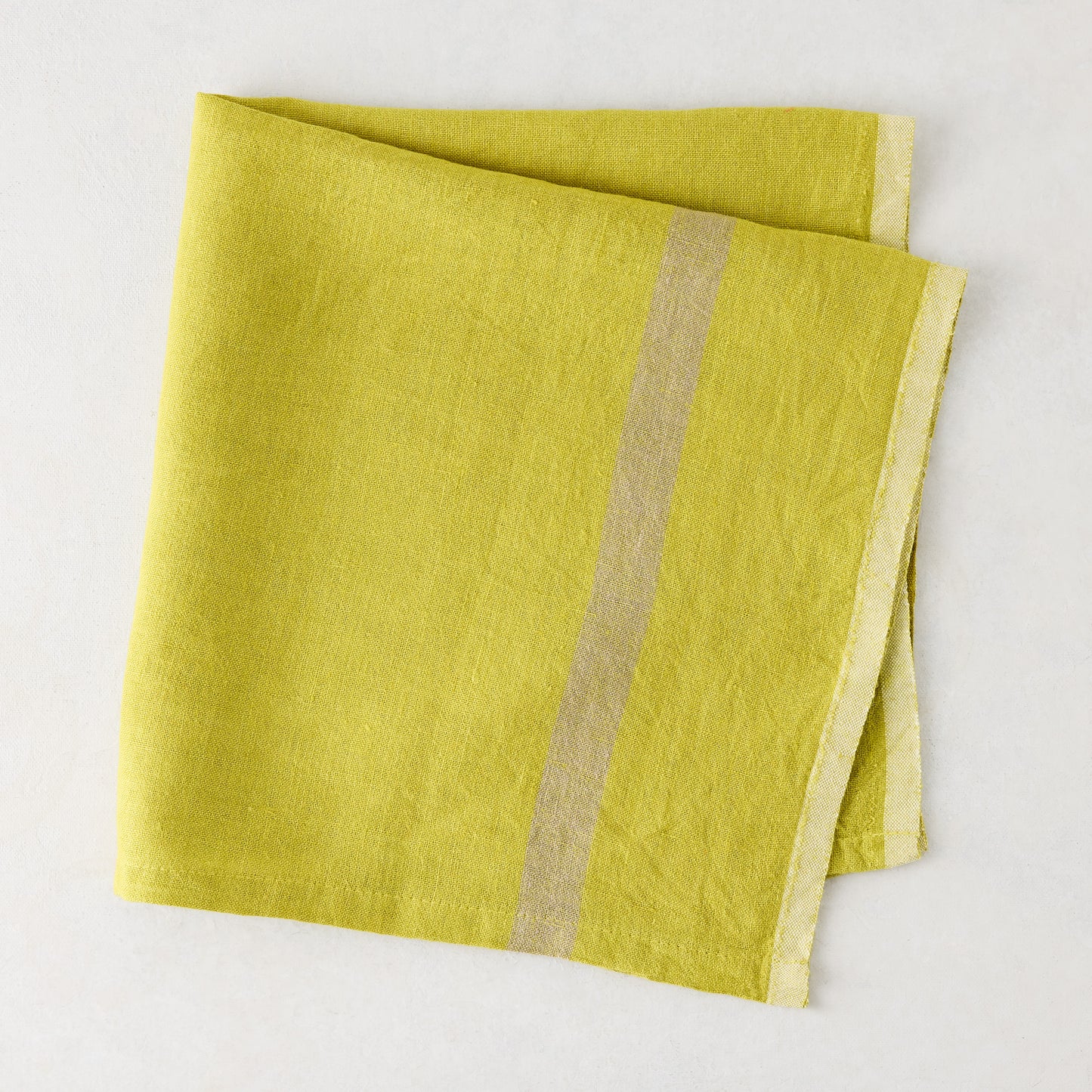 Folded Laundered Lime Green Linen Napkin with a paler vertical stripe, 22" square.