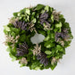 Green privet leaves wreath with bundles of purple lavender and dried white flowers.