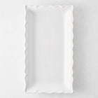 Rectangular white ceramic serve platter with a decorative scalloped edge, 13.77 inches long, made in Italy.