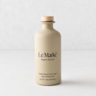 Le Marké olive oil in a matte beige ceramic bottle with a wooden cork stopper, 12.6 oz size.