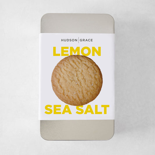 Hudson Grace Lemon Sea Salt Cookie Gift Tin with a single cookie on the label.