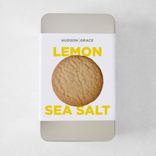 Hudson Grace Lemon Sea Salt Cookie Gift Tin with a single cookie on the label.