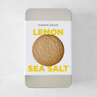 Hudson Grace Lemon Sea Salt Cookie Gift Tin with a single cookie on the label.