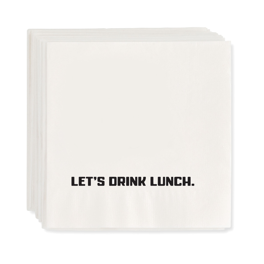 Stack of white paper cocktail napkins with "LET'S DRINK LUNCH." in black text.