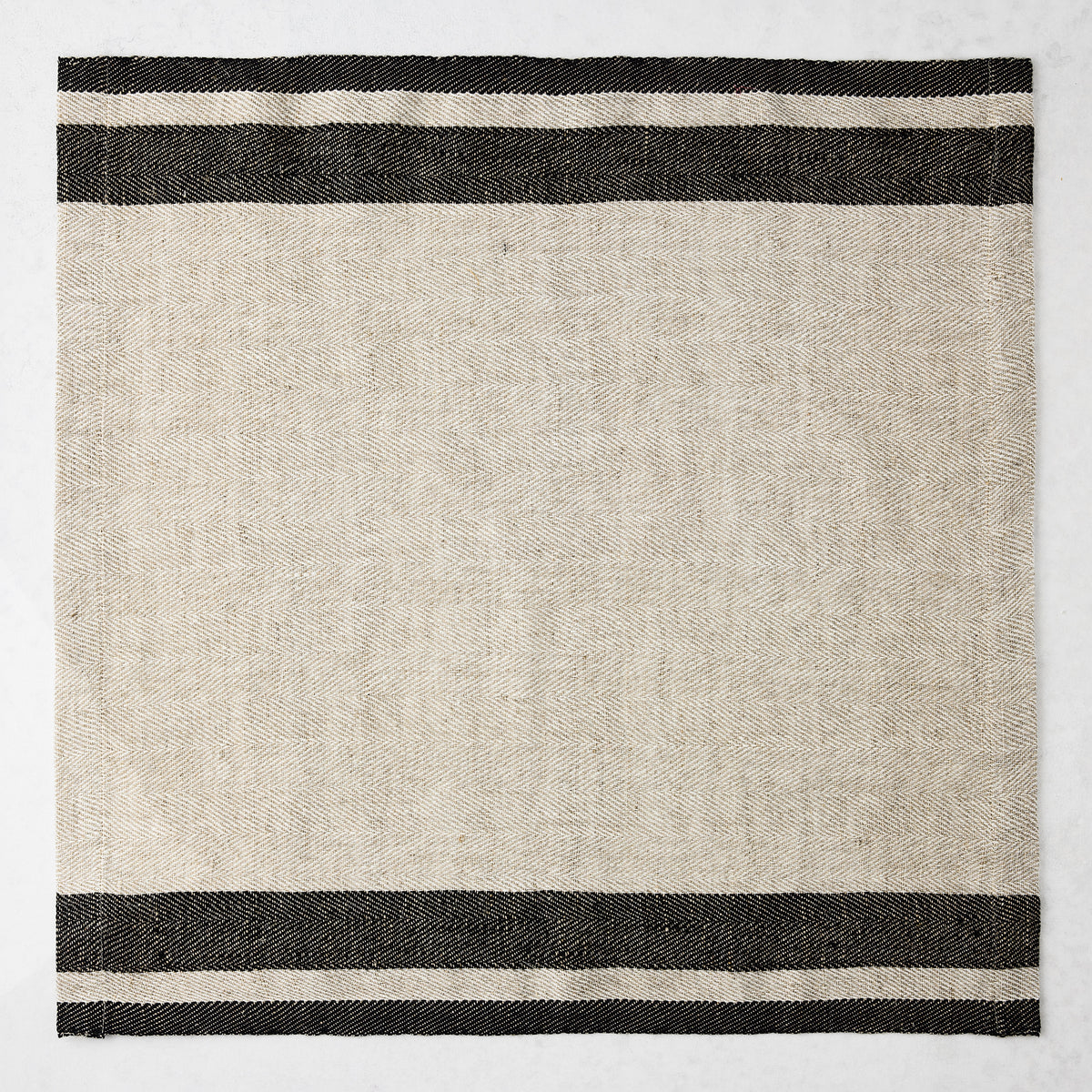 Lexington Charcoal Grey Stripe Border Napkin, 20" square linen/cotton blend, natural base with dark grey stripes.