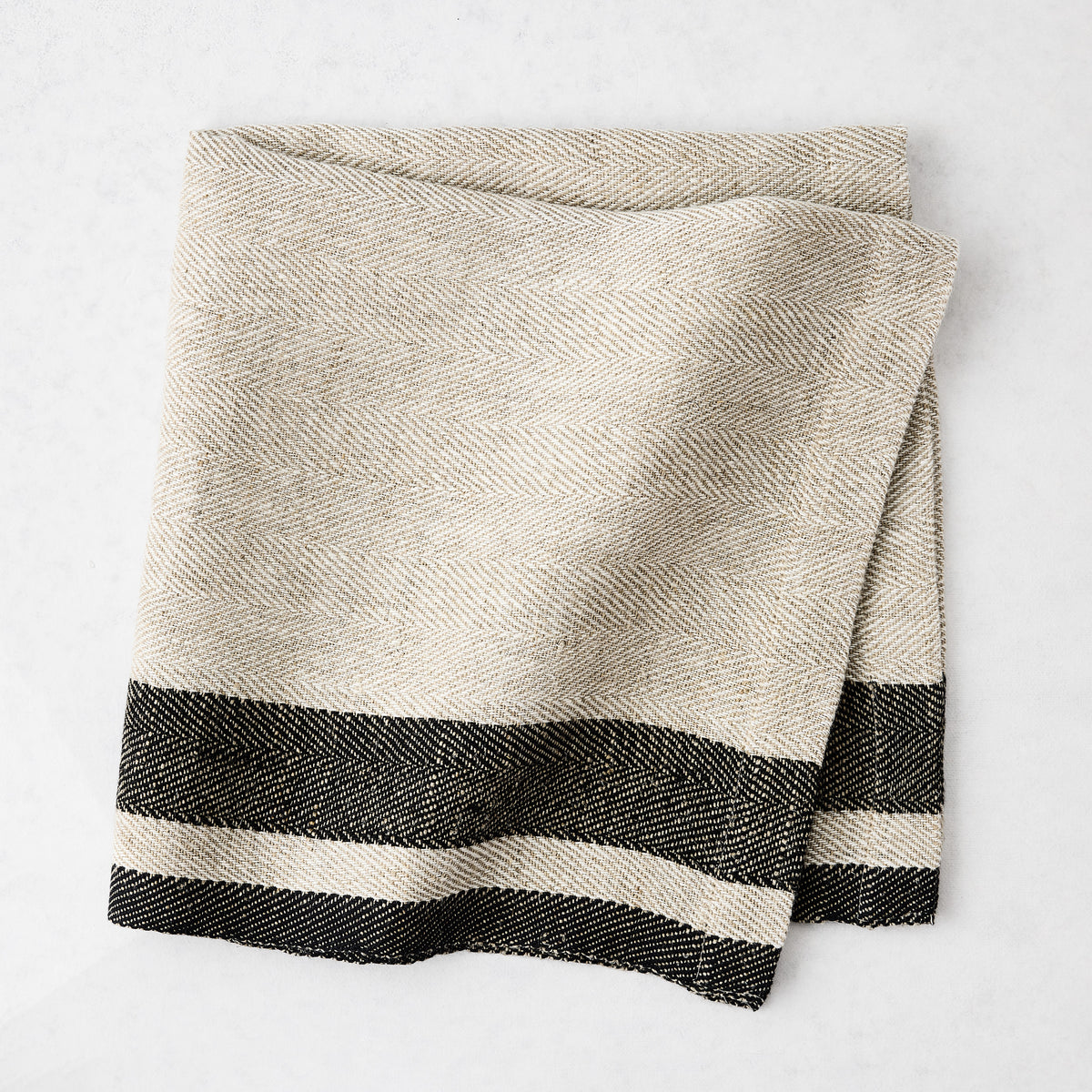 Lexington Charcoal Grey Stripe Border Napkin, natural linen-cotton blend with black striped edges.
