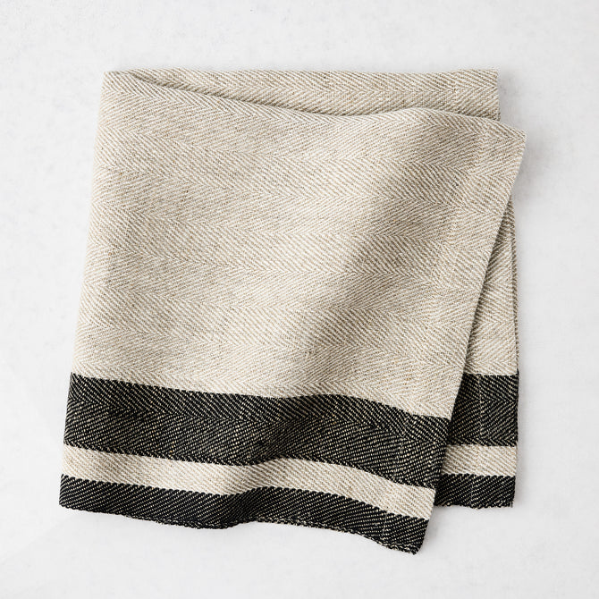Lexington Charcoal Grey Stripe Border Napkin, natural linen-cotton blend with black striped edges.