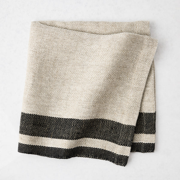 Lexington Charcoal Grey Stripe Border Napkin, natural linen-cotton blend with black striped edges.