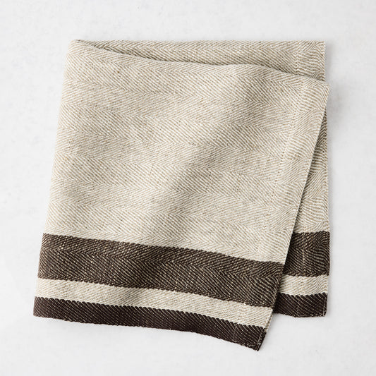 Lexington Chocolate Brown Stripe Border Napkin, folded, with natural toned base and dark brown stripes.