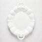 White oval ceramic serving platter with scalloped edges and handles.