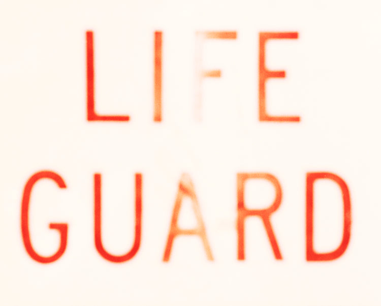 Matt Albiani's "LIFEGUARD" art print, red text with a faded effect on a light background.