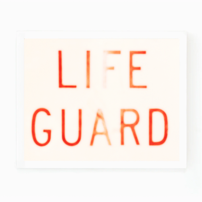 Matt Albiani's "Lifeguard" photograph: blurred red text on a light background in a white frame.