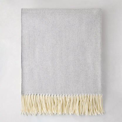 Light gray Italian herringbone throw blanket with cream fringe, 50% cotton, 50% soft acrylic.
