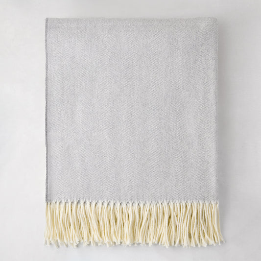 Light gray Italian herringbone throw blanket with cream fringe, 50% cotton, 50% soft acrylic.