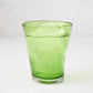 Light green Henri mouth-blown glass, 8 oz, with ice and water, showing unique imperfections and air bubbles.