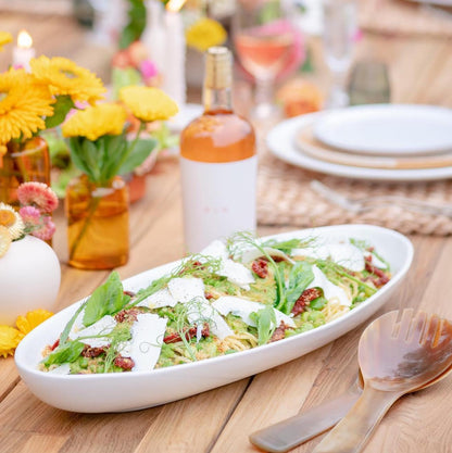 Light Horn Salad Server Set, 12" long, natural water buffalo horn, shown with salad on a wooden table.