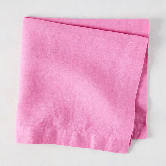 Lily HG Signature hand-dyed pink linen napkin, folded, 22-inch square.