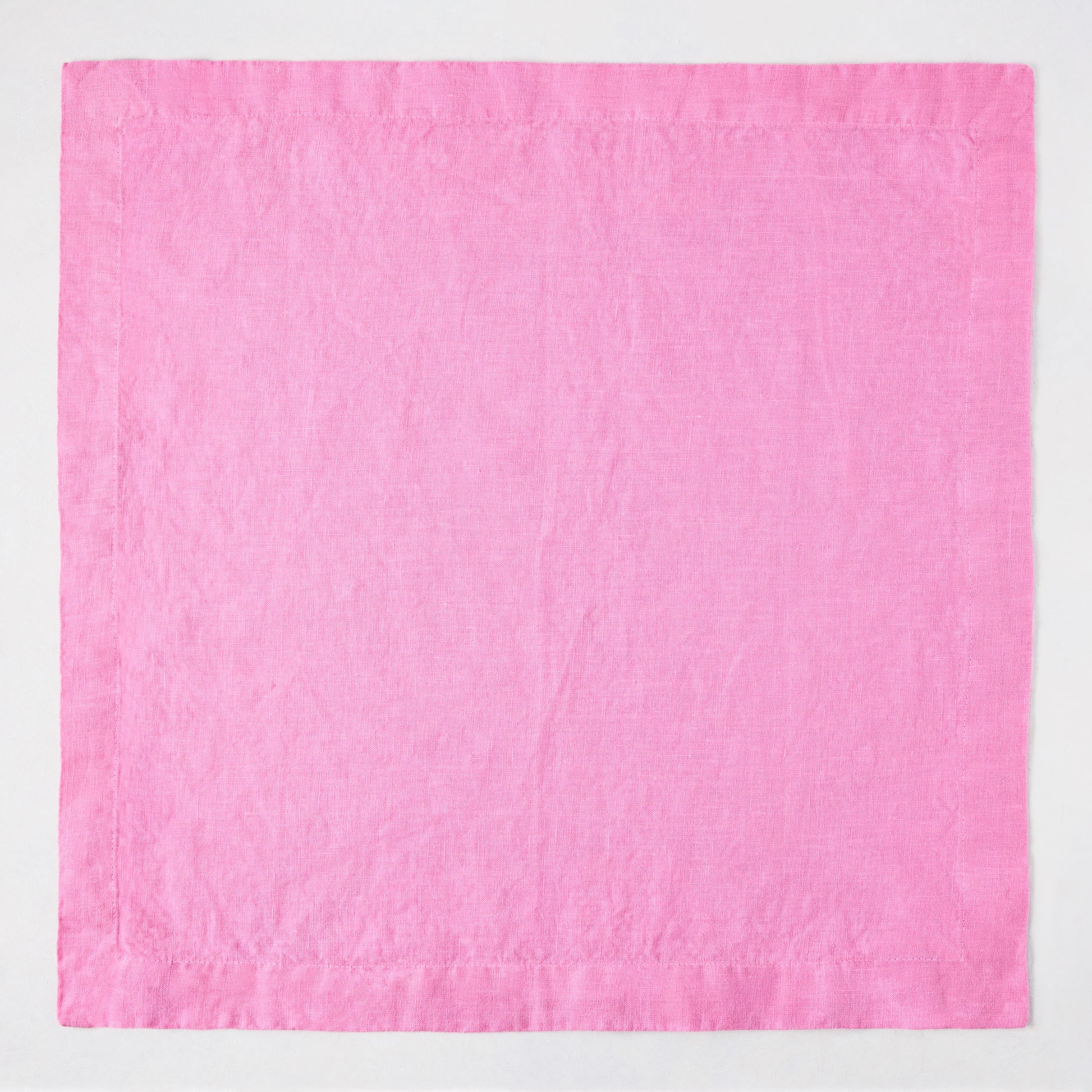 Lily HG Signature 22-inch square hand-dyed pink linen napkin with mitered corners.