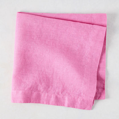 Lily HG Signature hand-dyed pink linen napkin, folded, 22-inch square.