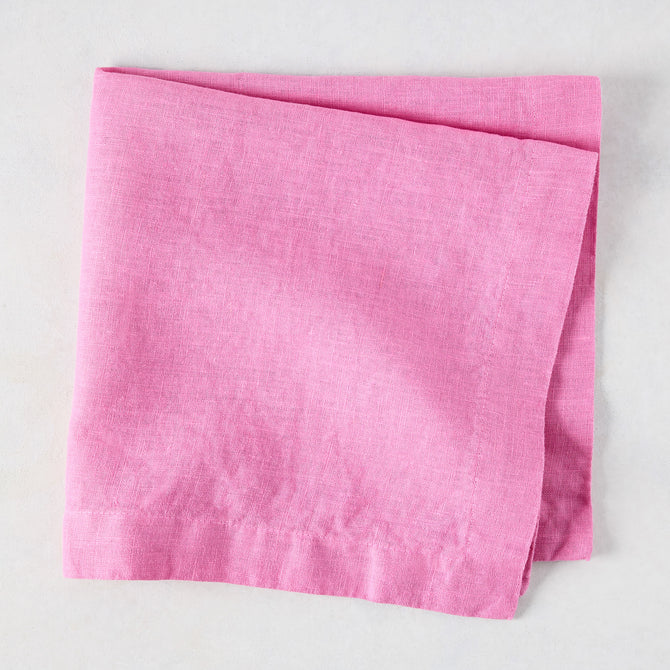 Lily HG Signature hand-dyed pink linen napkin, folded, 22-inch square.