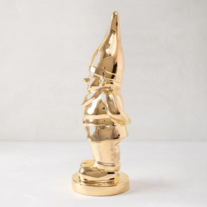 Limited Edition Gold Ceramic Holiday Gnome with brilliant hand-applied gold glaze, standing on a round base.