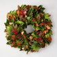 24-inch holiday wreath featuring fresh magnolia leaves, red berries, Carolina Sapphire greenery, and miniature pinecones.