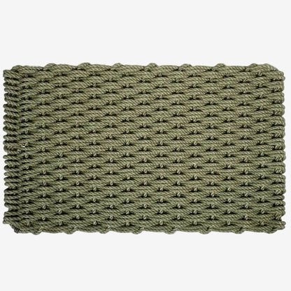 Loden green handwoven rope doormat with a tight, textured weave and braided edges.